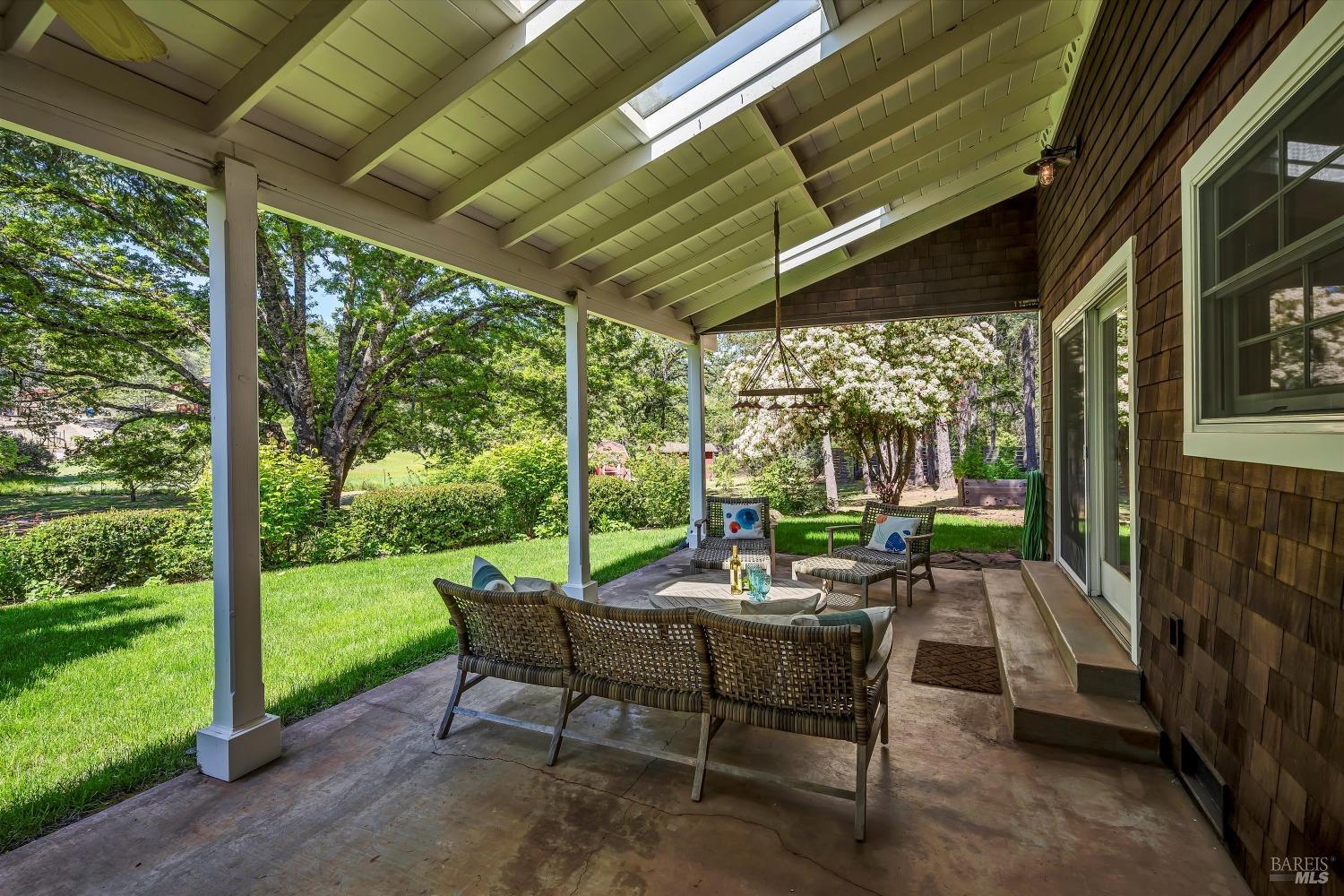 1065 Summit Lake Drive Angwin, CA 94508 - Photo 14 of 47 a view of a patio with a table chairs and a backyard