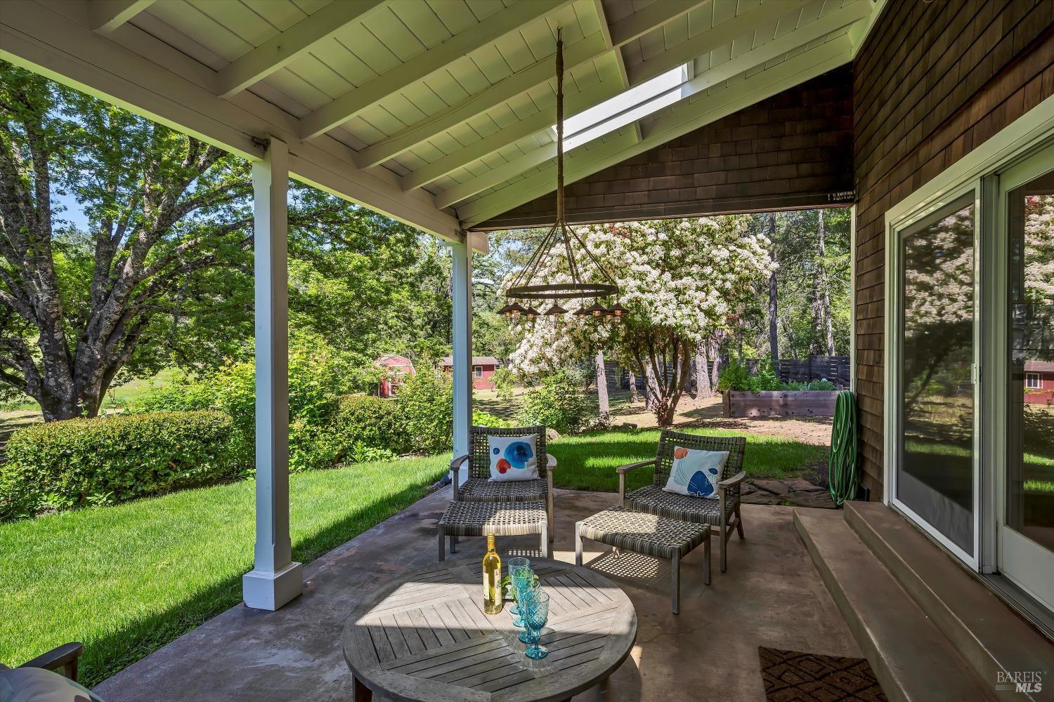1065 Summit Lake Drive Angwin, CA 94508 - Photo 15 of 47 a view of a patio with table and chairs potted plants with floor to ceiling window