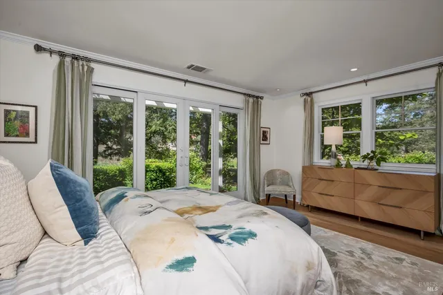 a bed room with a bed and a large window