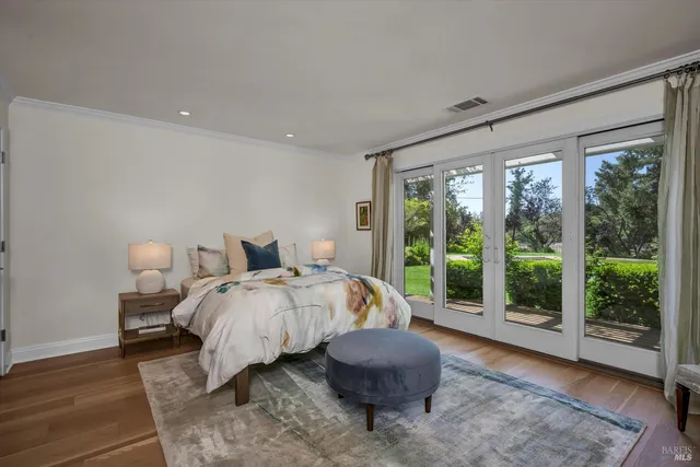 a spacious bedroom with a bed and glass window