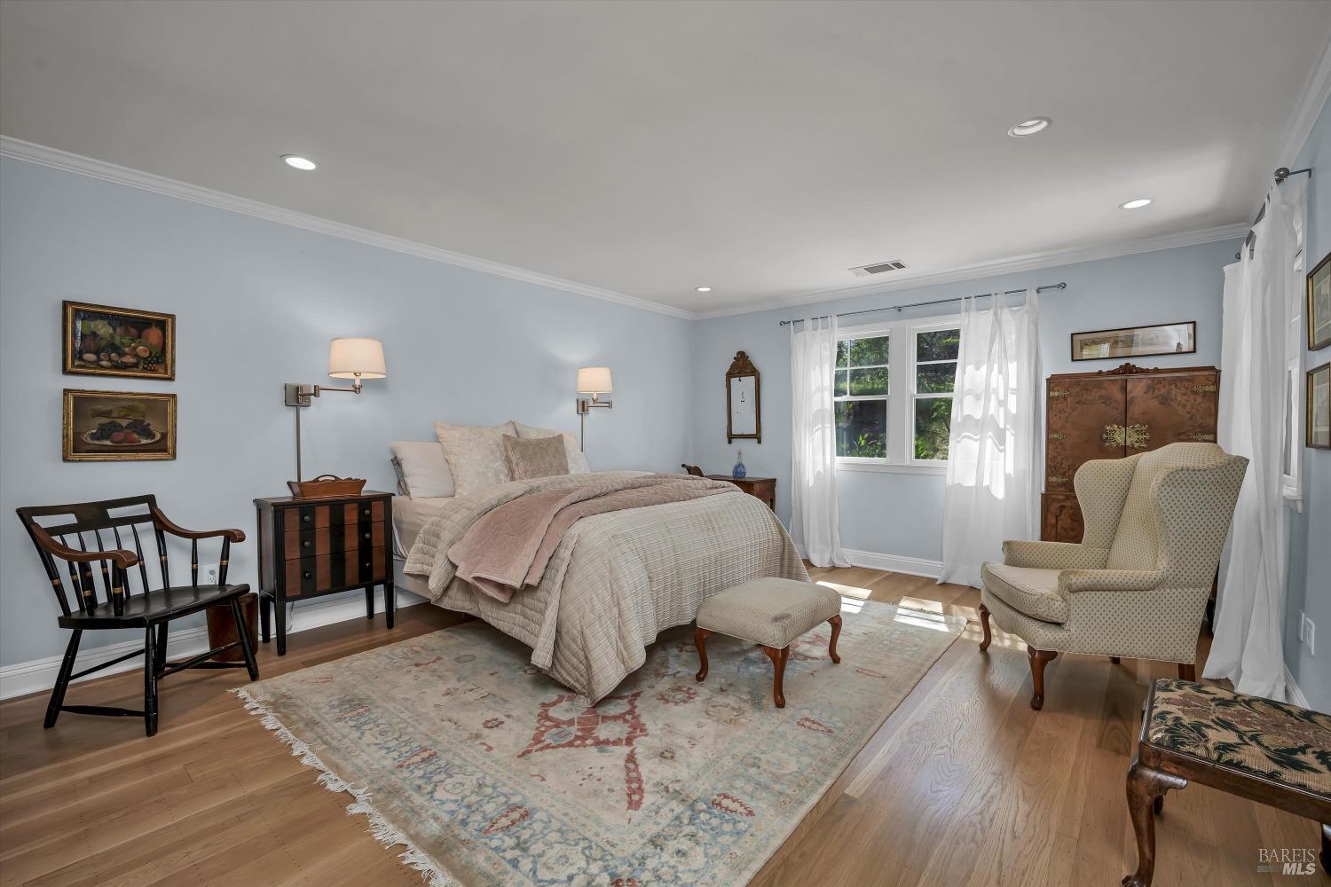 1065 Summit Lake Drive Angwin, CA 94508 - Photo 30 of 47 a spacious bedroom with a bed a couch and a dresser with wooden floor