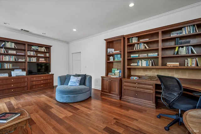 a living room with furniture and a book shelf