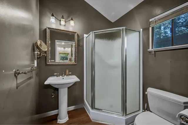 a bathroom with a sink mirror toilet and shower