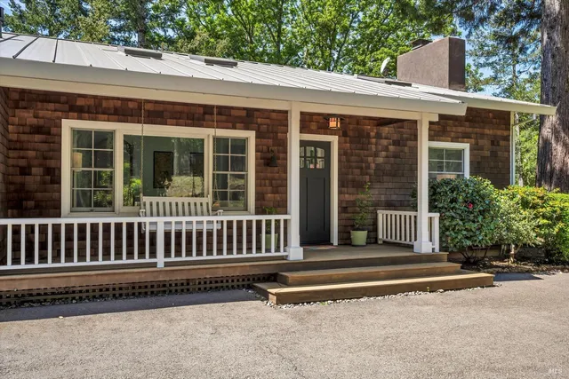 a view of a house with porch and sitting area