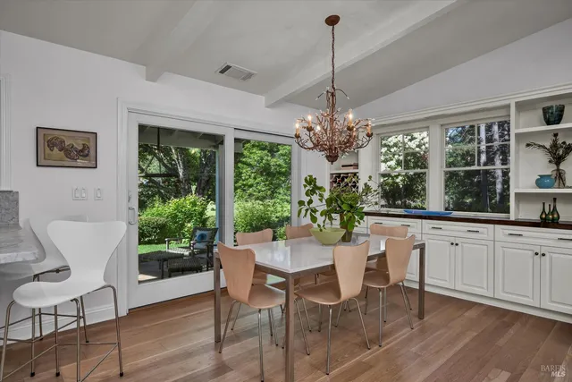 a dining room with furniture a chandelier and window