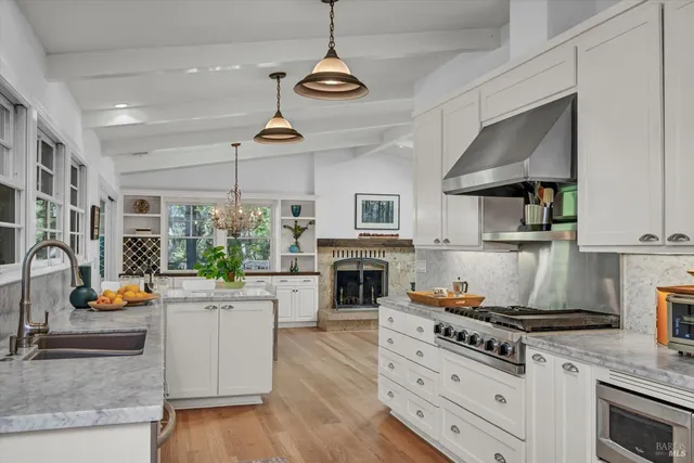 a kitchen with a stove a sink and a fireplace