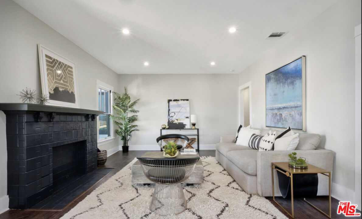 856 Serrano Place Los Angeles, CA 90029 - Photo 4 of 11 a living room with furniture and a fireplace
