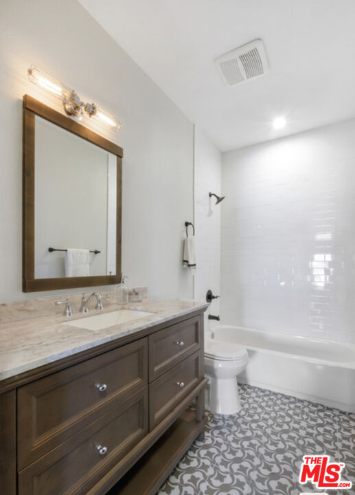856 Serrano Place Los Angeles, CA 90029 - Photo 7 of 11 a bathroom with a sink a toilet and shower