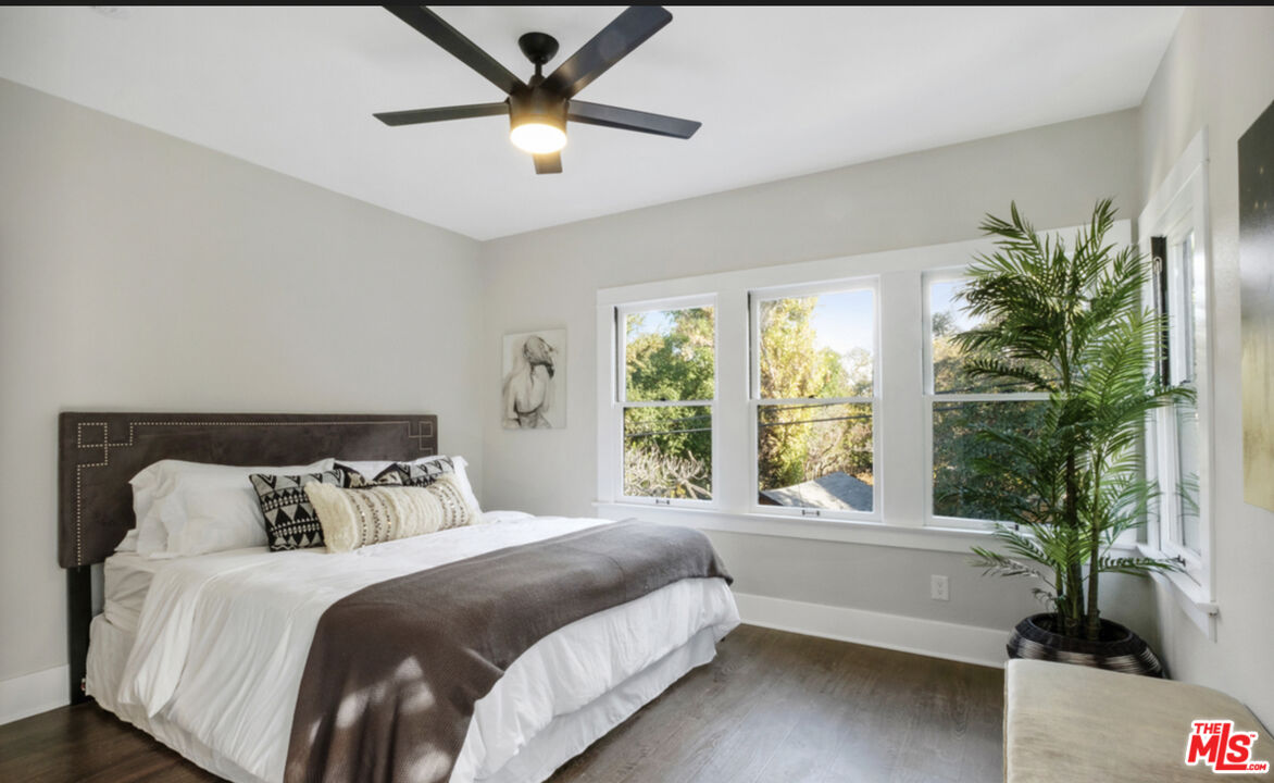 856 Serrano Place Los Angeles, CA 90029 - Photo 10 of 11 a bedroom with a large bed and a large window