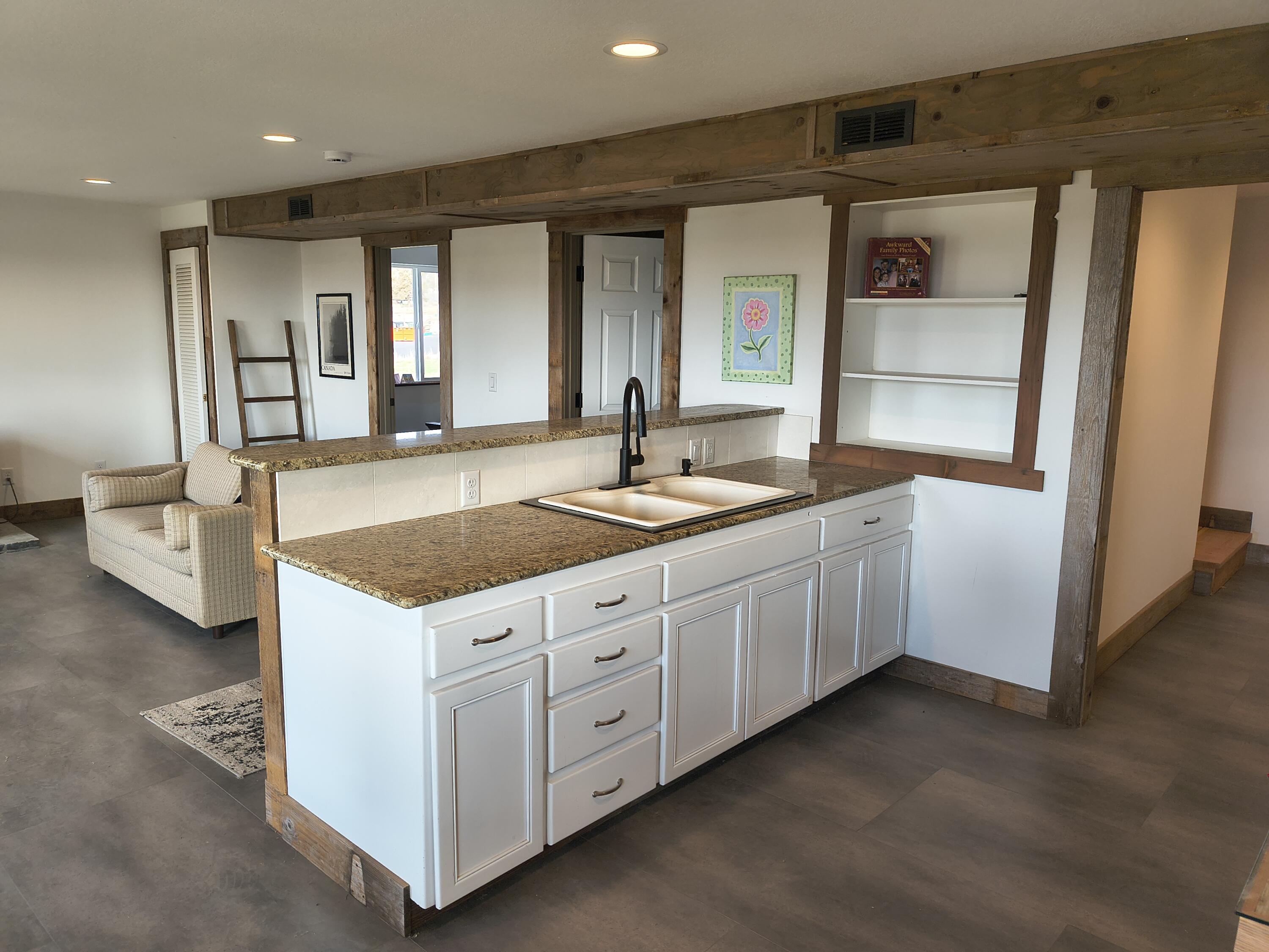 791 Southeast Grizzly Road Madras, OR 97741 - Photo 22 of 31 a spacious bathroom with a granite countertop sink and a mirror