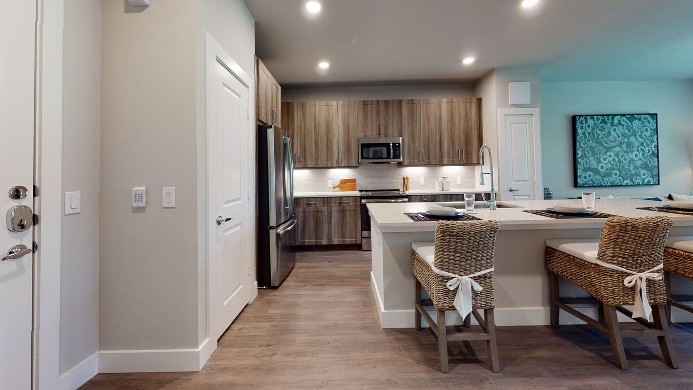24002 Colonial Parkway, Unit 4329 Katy, TX 77493 - Photo 4 of 31 a kitchen with kitchen island a dining table chairs stainless steel appliances and cabinets