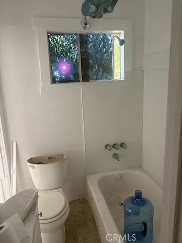 a bathroom with a toilet a sink and bathtub
