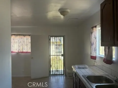 a kitchen with granite countertop a stove a sink and a window