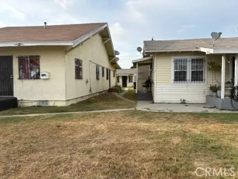 a view of a white house with a yard