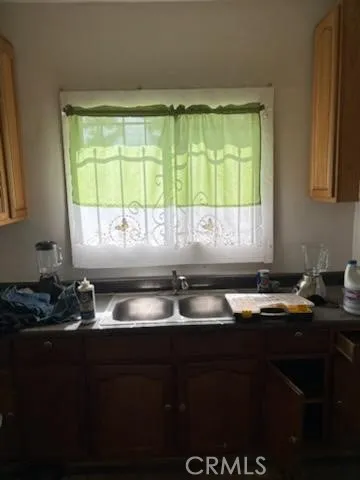 a kitchen with granite countertop a sink and a window