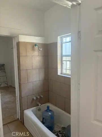a bathroom with a tub and glass door