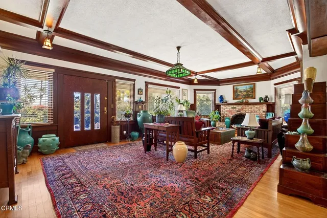 a living room with furniture a fireplace and a large window
