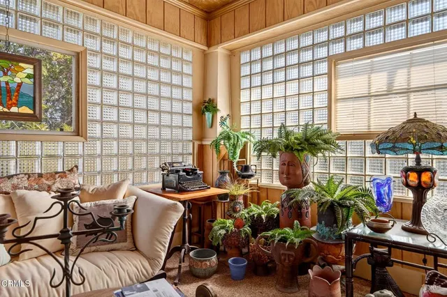 a living room with lots of books and furniture