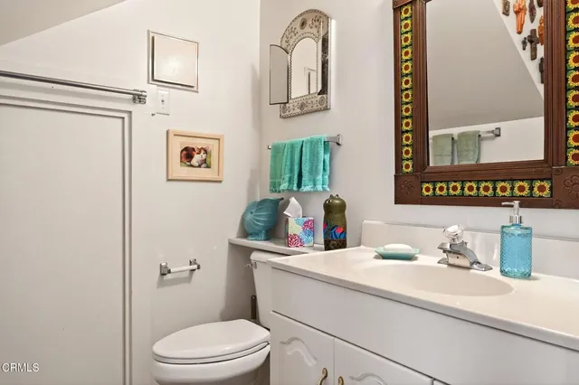 a view of a balcony with two potted plants and wooden floor