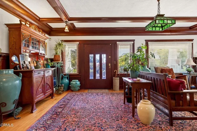 a living room with furniture a fireplace and a floor to ceiling window