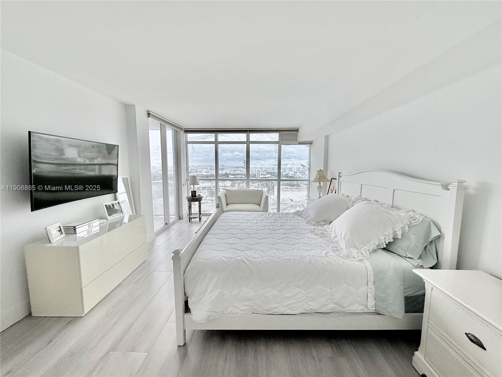 1800 Sunset Harbour Drive, Unit 2005 Miami Beach, FL 33139 - Photo 12 of 27 a bedroom with a bed and a flat screen tv