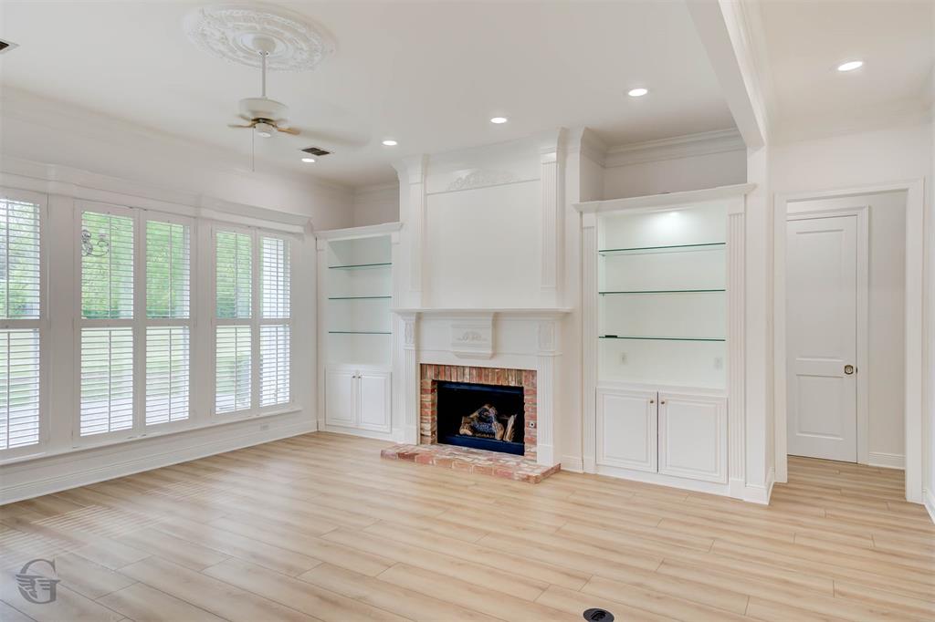 316 Autumn Ridge Drive Bossier City, LA 71111 - Photo 4 of 40 an empty room with wooden floor fireplace and windows