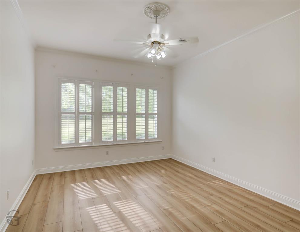 316 Autumn Ridge Drive Bossier City, LA 71111 - Photo 10 of 40 a view of an empty room with wooden floor and a window