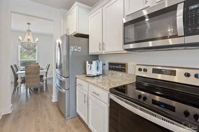 a kitchen with stainless steel appliances a sink a stove and cabinets