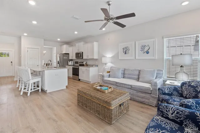 a living room with furniture and kitchen view