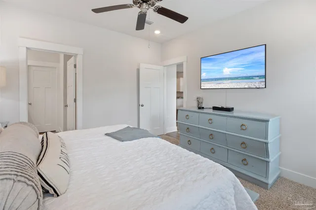 a bedroom with a bed and a painting on the wall