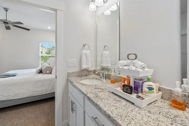 a bedroom with a bed table and window