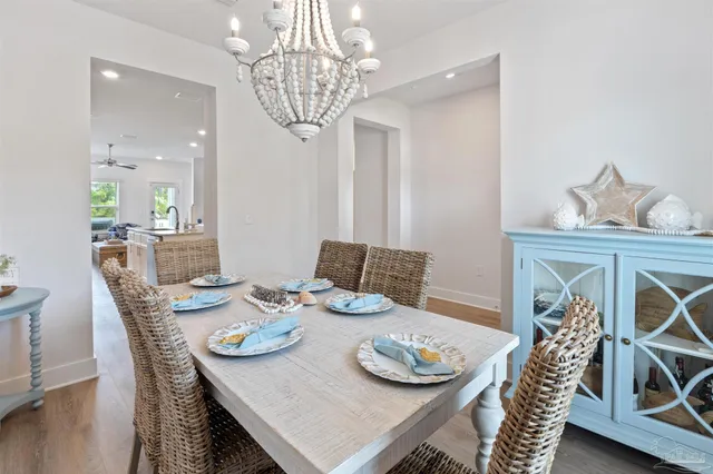 a view of a dining room with furniture wooden floor and chandelier