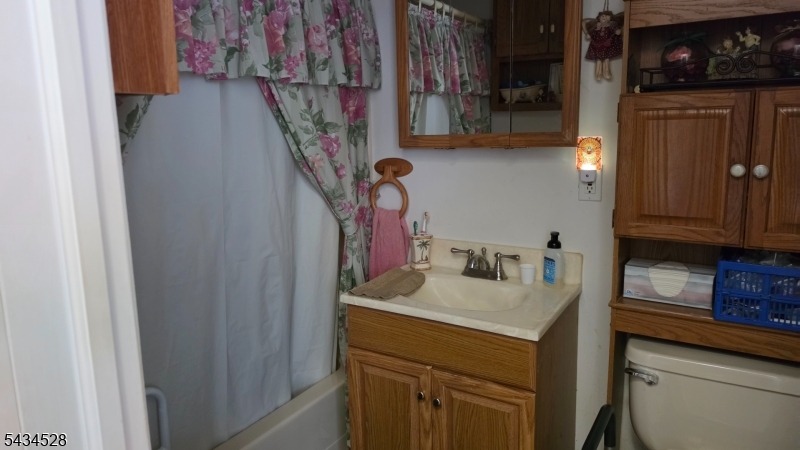 1115 West Camplain Road Manville, NJ 08835 - Photo 6 of 18 a bathroom with a sink and a mirror