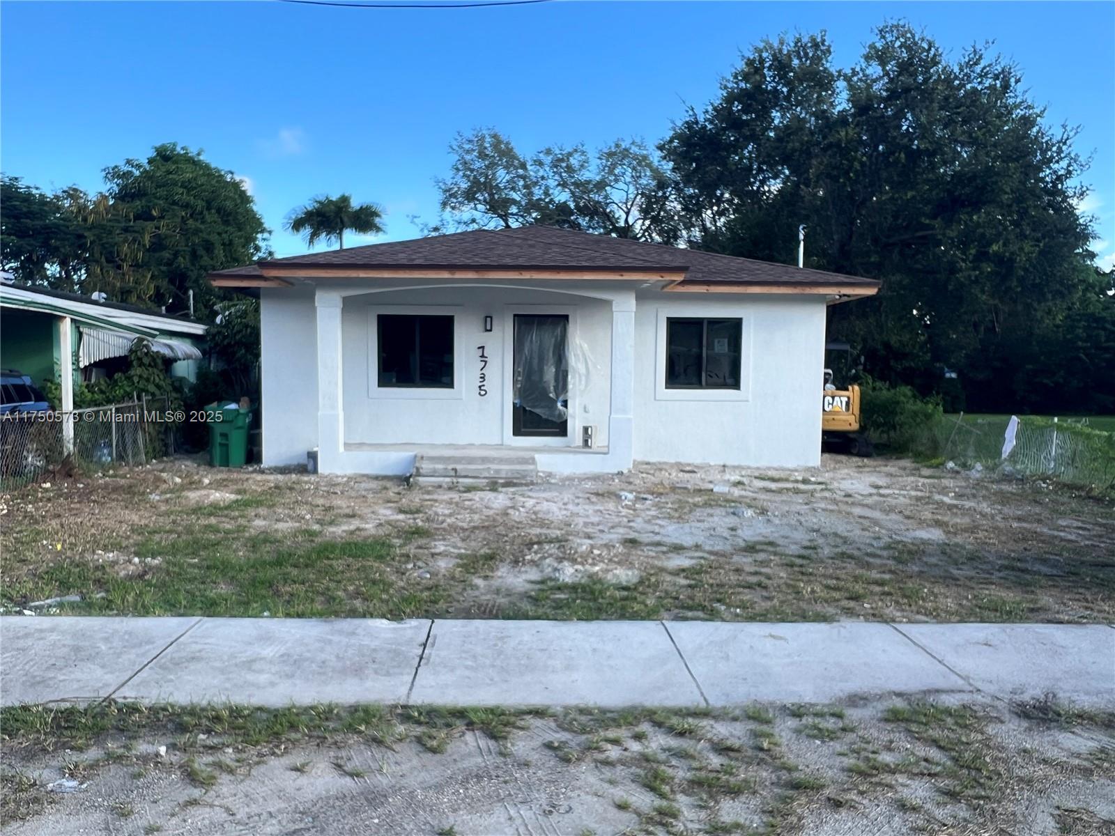 1735 Northwest 84th Street Miami, FL 33147 - Photo 2 of 14 a house that has a tree in front of it