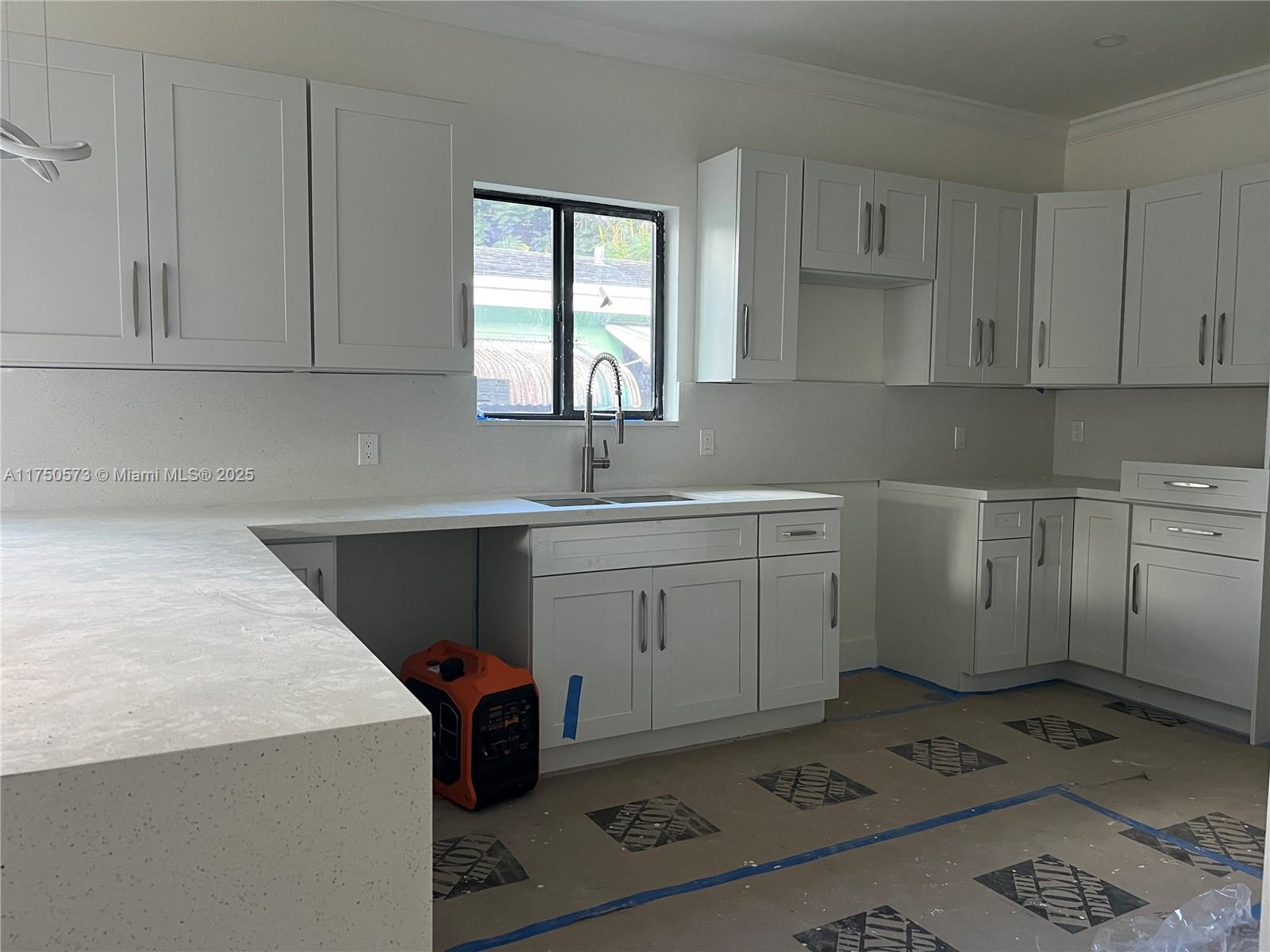 1735 Northwest 84th Street Miami, FL 33147 - Photo 5 of 14 a utility room with cabinets washer and dryer