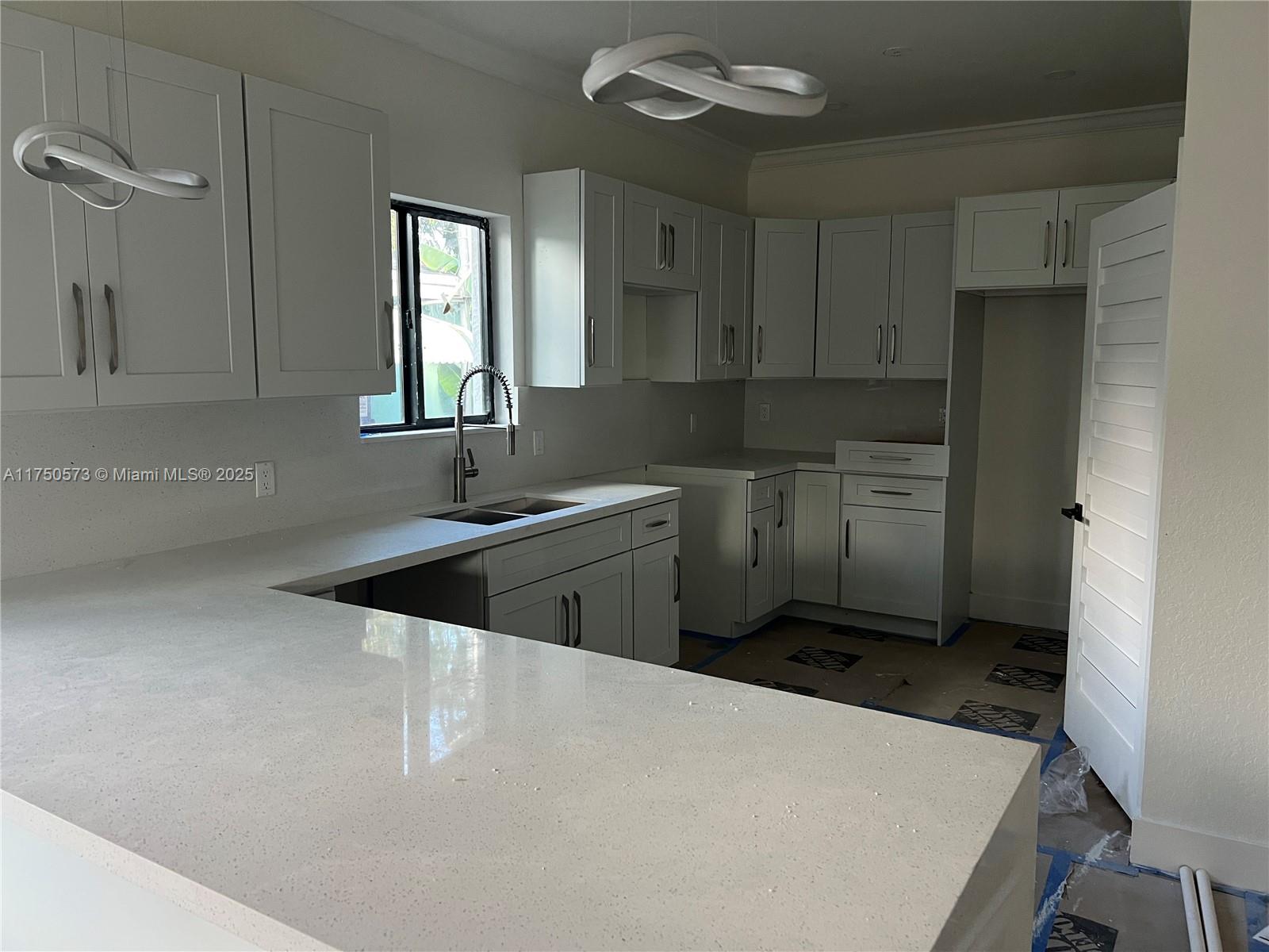 1735 Northwest 84th Street Miami, FL 33147 - Photo 7 of 14 a kitchen with stainless steel appliances a sink stove and refrigerator