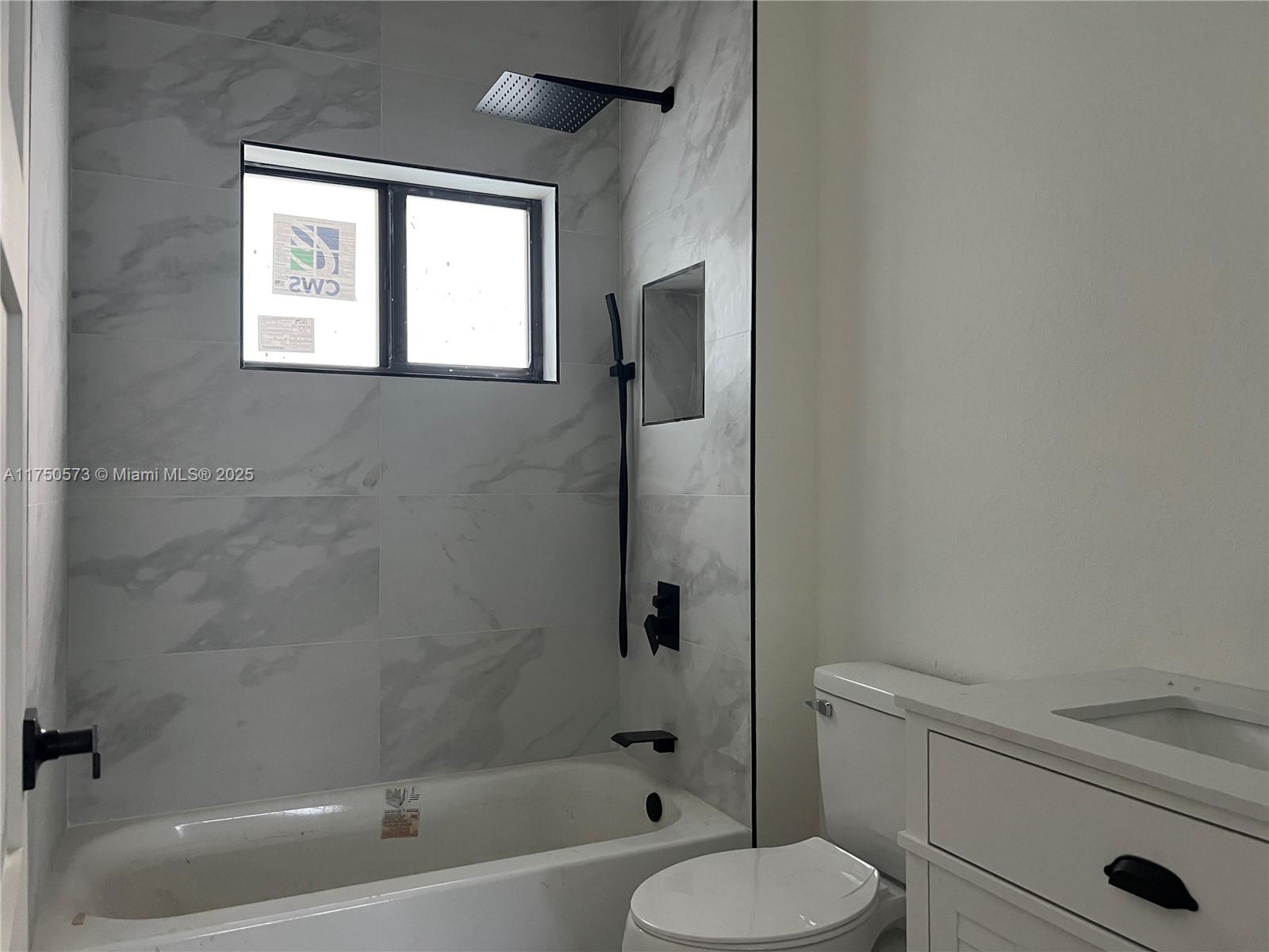 1735 Northwest 84th Street Miami, FL 33147 - Photo 8 of 14 a bathroom with a toilet a sink and bathtub