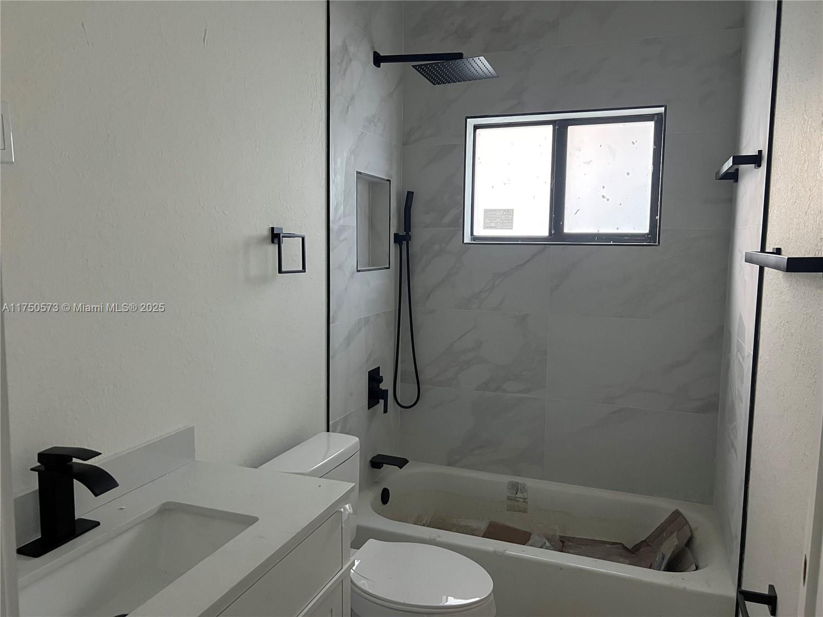 1735 Northwest 84th Street Miami, FL 33147 - Photo 10 of 14 a bath room with a toilet sink and a bath tub