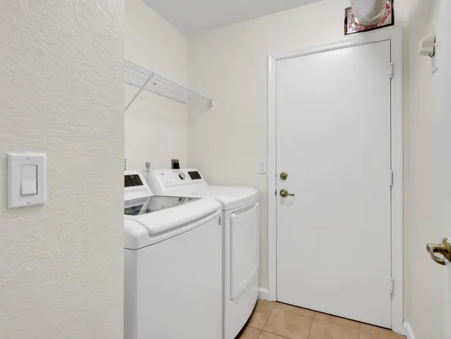 a view of a bathroom from a hallway with wooden floor