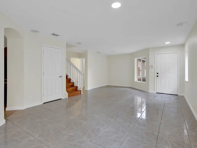 an empty room with windows and closet