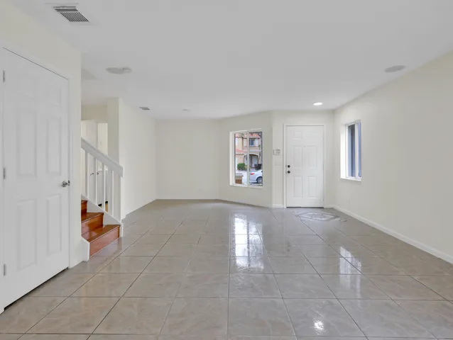 a view of a hallway with wooden floor and entryway