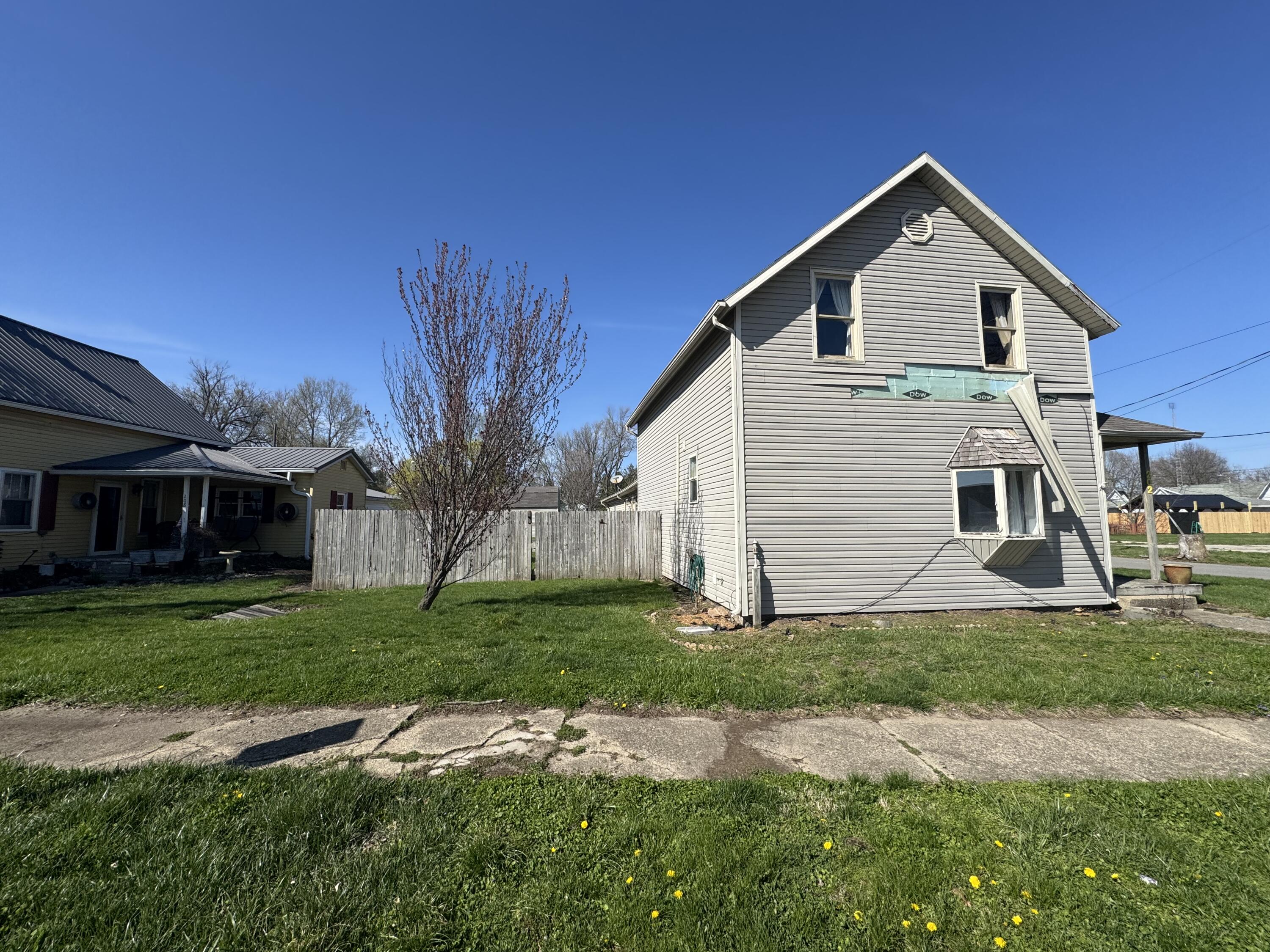 202 West Walnut Street Akron, IN 46910 - Photo 3 of 10 a front view of a house with a yard and garage