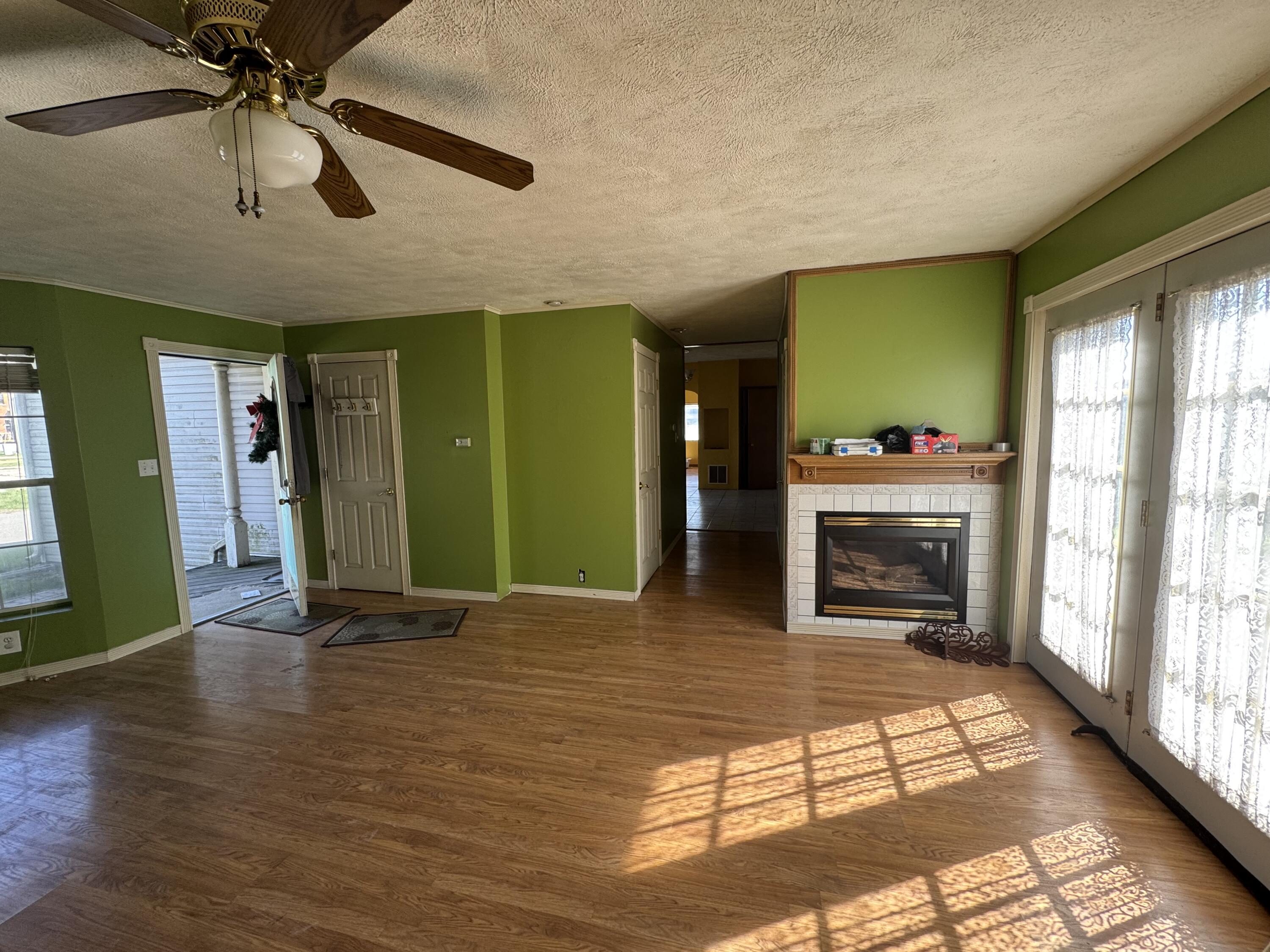 202 West Walnut Street Akron, IN 46910 - Photo 4 of 10 a view of an empty room with window and wooden floor