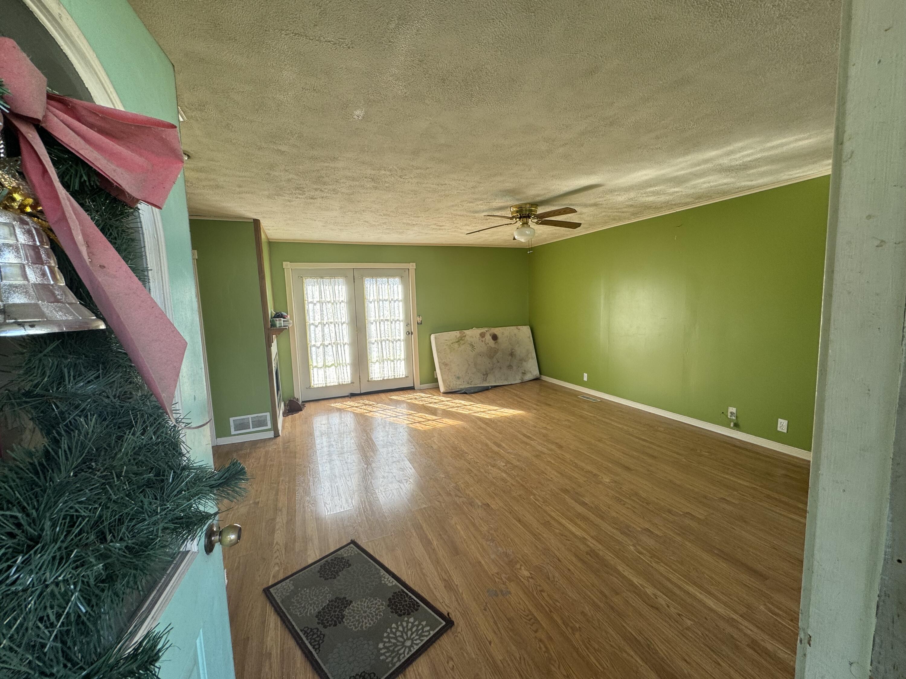 202 West Walnut Street Akron, IN 46910 - Photo 5 of 10 a view of an empty room with wooden floor and a window
