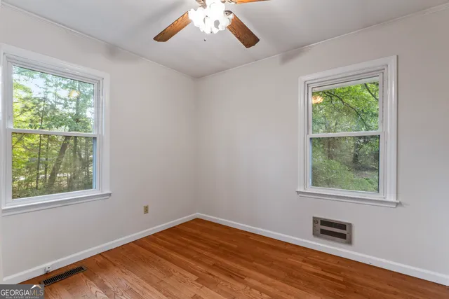 a bathroom with a toilet a sink and a window