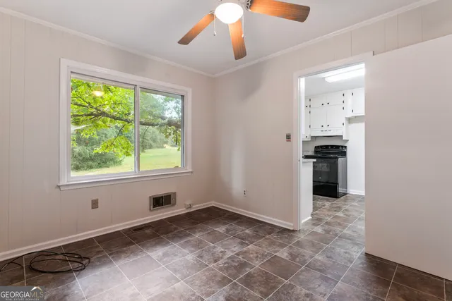 a kitchen with granite countertop white cabinets white appliances and a sink