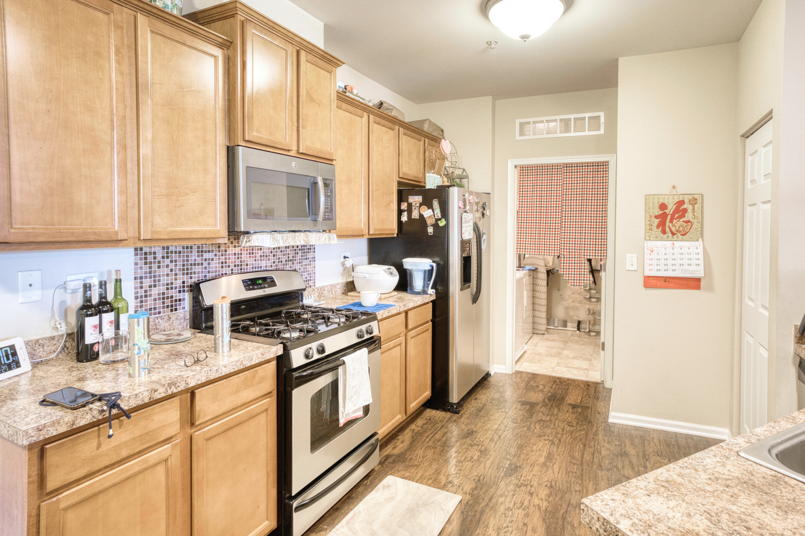 7520 Claridge Drive, Unit H Bridgeview, IL 60455 - Photo 8 of 22 a kitchen with stainless steel appliances granite countertop a stove a sink and a refrigerator