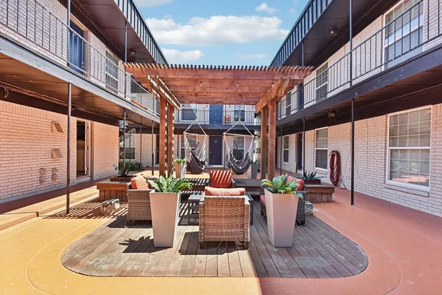 a view of a patio with dining table and chairs