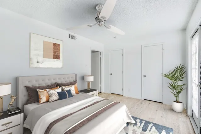 a bedroom with a bed and a potted plant