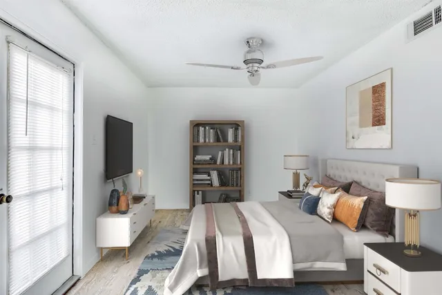 a bedroom with a bed and wooden floor